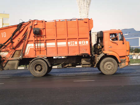 Kazakhstan, Ust-Kamenogorsk, August 16, 2019: Garbage truck in the city. Orange truck. Kamazのeditorial素材