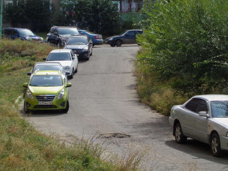 Kazakhstan, Ust-Kamenogorsk, September 1, 2019: Cars parked along the street.のeditorial素材