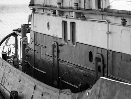 Small ship moored at Ust-Kamenogorsk reservoir. Ship fragment. Black and whiteのeditorial素材