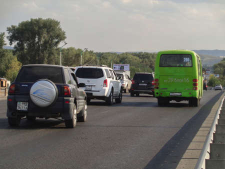 Kazakhstan, Ust-Kamenogorsk, august 16, 2019: Traffic on one of the streets of the city. Bridge. Public transportのeditorial素材
