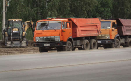 Kazakhstan, Ust-Kamenogorsk, august 21, 2019: Construction engineering. Dump trucks and excavators. Road constructionのeditorial素材
