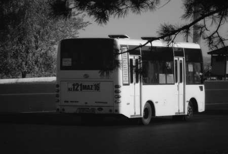 Kazakhstan, Ust-Kamenogorsk, september 10, 2019: Small city bus on one of the city streets. Public transport. Black and whiteのeditorial素材