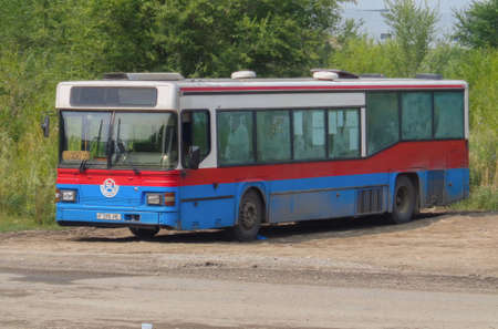 Kazakhstan, Ust-Kamenogorsk, july 28, 2019: Scania CN113. Old bus on one of the city streets. Public transport. Red and blue. Scania busesのeditorial素材