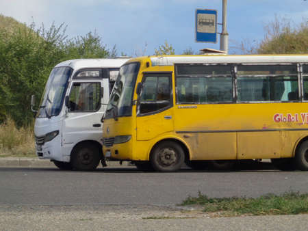 Kazakhstan, Ust-Kamenogorsk, September 7, 2019: Two parked buses. Bus terminal. Public transport. Passenger transportationのeditorial素材