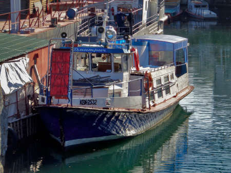 Kazakhstan, Ust-Kamenogorsk, October 4, 2019: Small ship moored at Ust-Kamenogorsk reservoir. The Ust-Kamenogorsk Hydroelectric Power Plantのeditorial素材