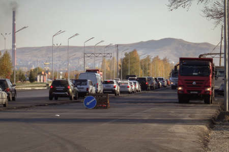 Kazakhstan, Ust-Kamenogorsk, September 10, 2019: Traffic on one of the streets of the city. Evening. Road constructionのeditorial素材