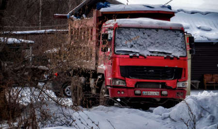 Kazakhstan, Ust-Kamenogorsk, December 19, 2019: Red CNHTC Howo Sinotruk dump truck. Grungeのeditorial素材