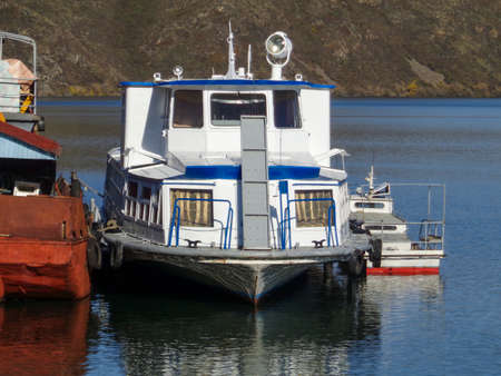 Small ship moored at Ust-Kamenogorsk reservoir. The Ust-Kamenogorsk Hydroelectric Power Plant. Kazakhstanのeditorial素材