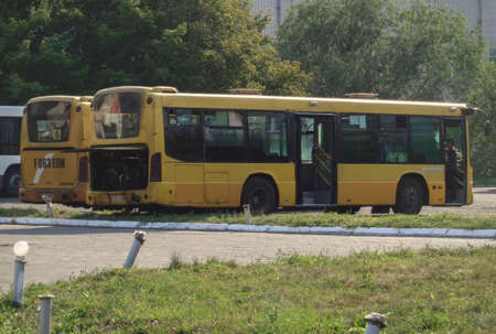 Kazakhstan, Ust-Kamenogorsk, August 16, 2019: Two Chinese Zhong Tong Buses. Yellow. Bus stopのeditorial素材