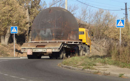 Kazakhstan, Ust-Kamenogorsk, october 4, 2019: Yellow truck with trailer. Kamaz truck. Metal structureのeditorial素材