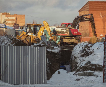 Kazakhstan, Ust-Kamenogorsk, december, 2018: Two excavators work on construction site