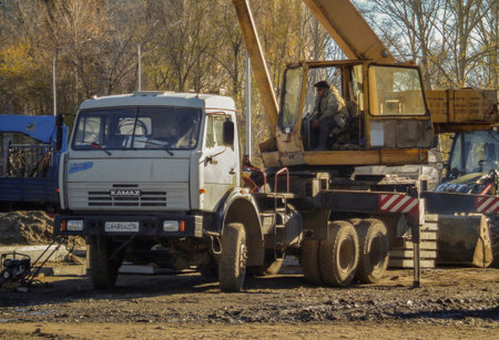 Kazakhstan, Ust-Kamenogorsk, october 24, 2018: Crane operator at work. Truck crane on KAMAZ....