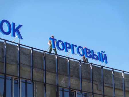 Kazakhstan, Ust-Kamenogorsk, june 22, 2020: Construction crew installing a sign. New shopping mallのeditorial素材