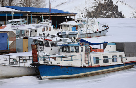 kazakhstan, Ust-Kamenogorsk, february 15, 2025: Small ships moored at Ust-Kamenogorsk reservoir. Ships frozen in iceのeditorial素材