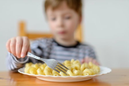 Delicious food, child eats pasta