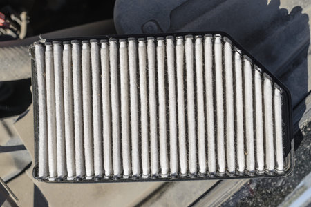 Dirty old passenger car engine air filter - top view