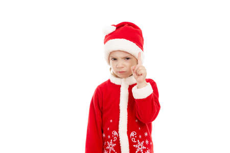 A small white boy is standing on a white isolated background and showing number two with his fingers while smiling broadly and his hair is tousled.の写真素材