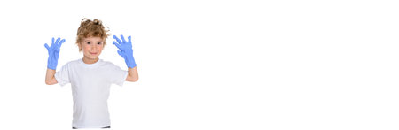 Little handsome boy dressed in a white T-shirt with protective medical blue gloves on his hands stands on a white isolated background. He is happy. Bannerの写真素材