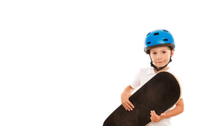 Little kid with skateboard in hands on white isolated backgroundの写真素材