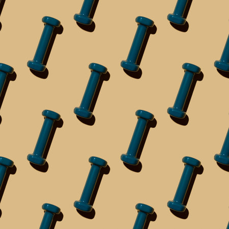 Fitness dumbbells blue on a beige background, pattern, top view