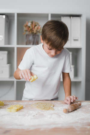 Happy boy child preparing homemade cookiesの写真素材