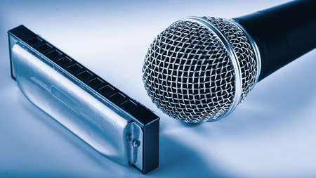 microphone and harmonica in cool metallic tones, shallow depth of fieldの写真素材
