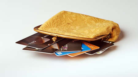 yellow old wallet with fragment of discont and credit card on gray backgroundの写真素材