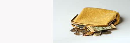 old wallet with a fragment of ten dollars bill and credit card on gray background, social pension banner conceptの写真素材