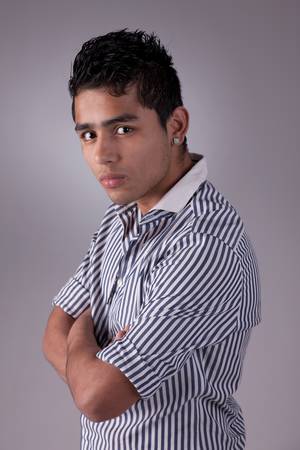 young and handsome latin man,serious, studio shotの写真素材