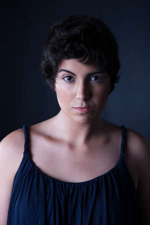 beautiful young woman, looking to camera, studio shotの写真素材