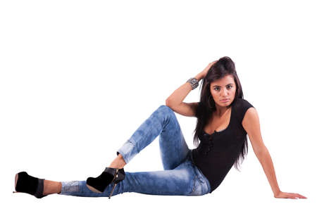 beautiful and sensual latin woman, on the floor, looking to camera, studio shotの写真素材