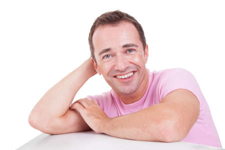 Portrait of a handsome middle-age man smiling, on white background. Studio shotの写真素材