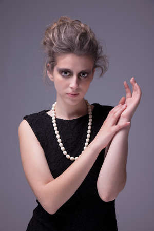 beautiful young woman with elegant black dress, studio shotの写真素材