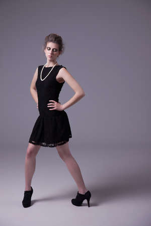 beautiful young woman with elegant black dress, studio shotの写真素材