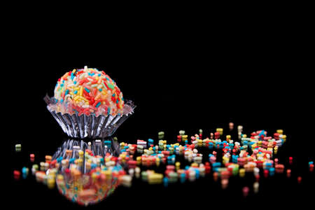 chocolate - colored brigadier, on black with reflexion, studio shotの写真素材