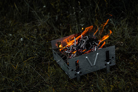 Burning coals in the grill, flame and smoke.