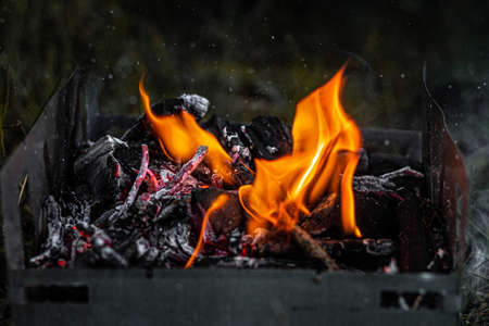 Burning coals in the grill, flame and smoke.の写真素材