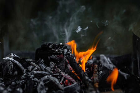 Burning coals in the grill, flame and smoke.の写真素材