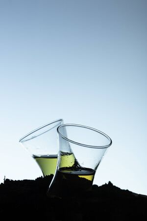 Two shots of whiskey on blue backgroundの写真素材