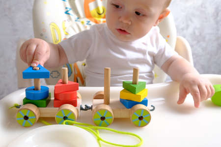child boy playing with toys indoors at homeの写真素材