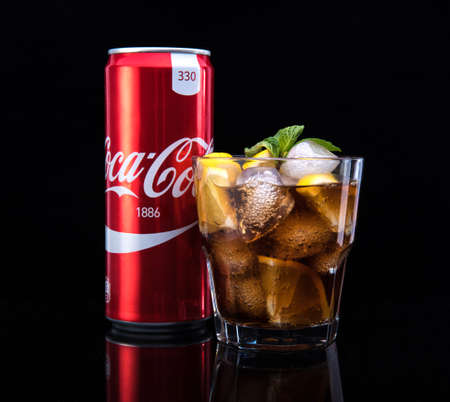 MINSK, BELARUS - JANUARY 05, 2017: Editorial photo can and glass of Coca-Cola with ice on dark background. Coca-Cola is a carbonated soft drink sold throughout the worldのeditorial素材