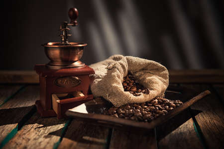 Coffee mill on dark rustic background. Wood tableの写真素材