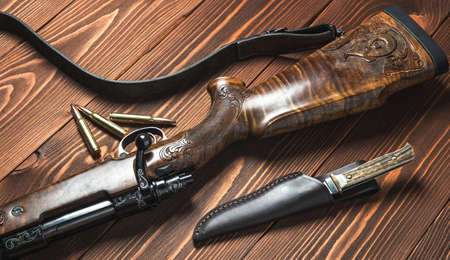 Hunting equipment with knife on old wooden backgroundの写真素材