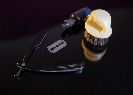 vintage razor and shaving brush on a black background with reflection.の写真素材