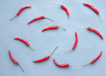 Red hot chili peppers on blue background. Flat lay, top viewの写真素材