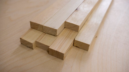 Wooden building blocks on a table in a carpentry workshop.の写真素材