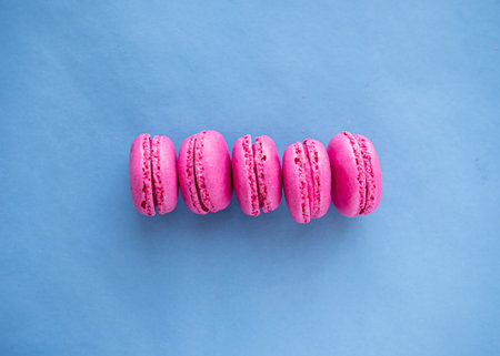 Pink macaroons on blue background. top view, copy spaceの写真素材
