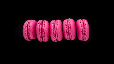 Pink macaroons isolated on black background. sweet macaroon.の写真素材
