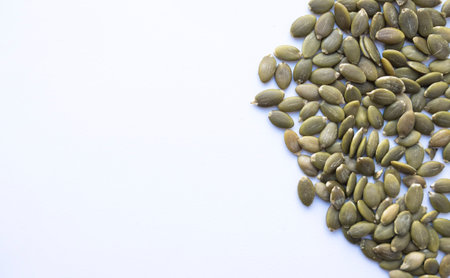 pumpkin seeds on white background, healthy food and nutrition conceptの写真素材