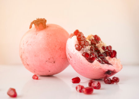 Ripe pomegranate fruit on a white background, close upの写真素材